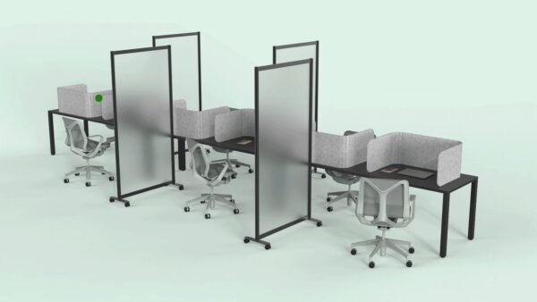 A long wooden table, set up for an office. Each work area is divided with a Hide privacy screen, with the laptop closed in front of it. Each middle seat (of each side of the table) has the Split semi-clear full length privacy screen.